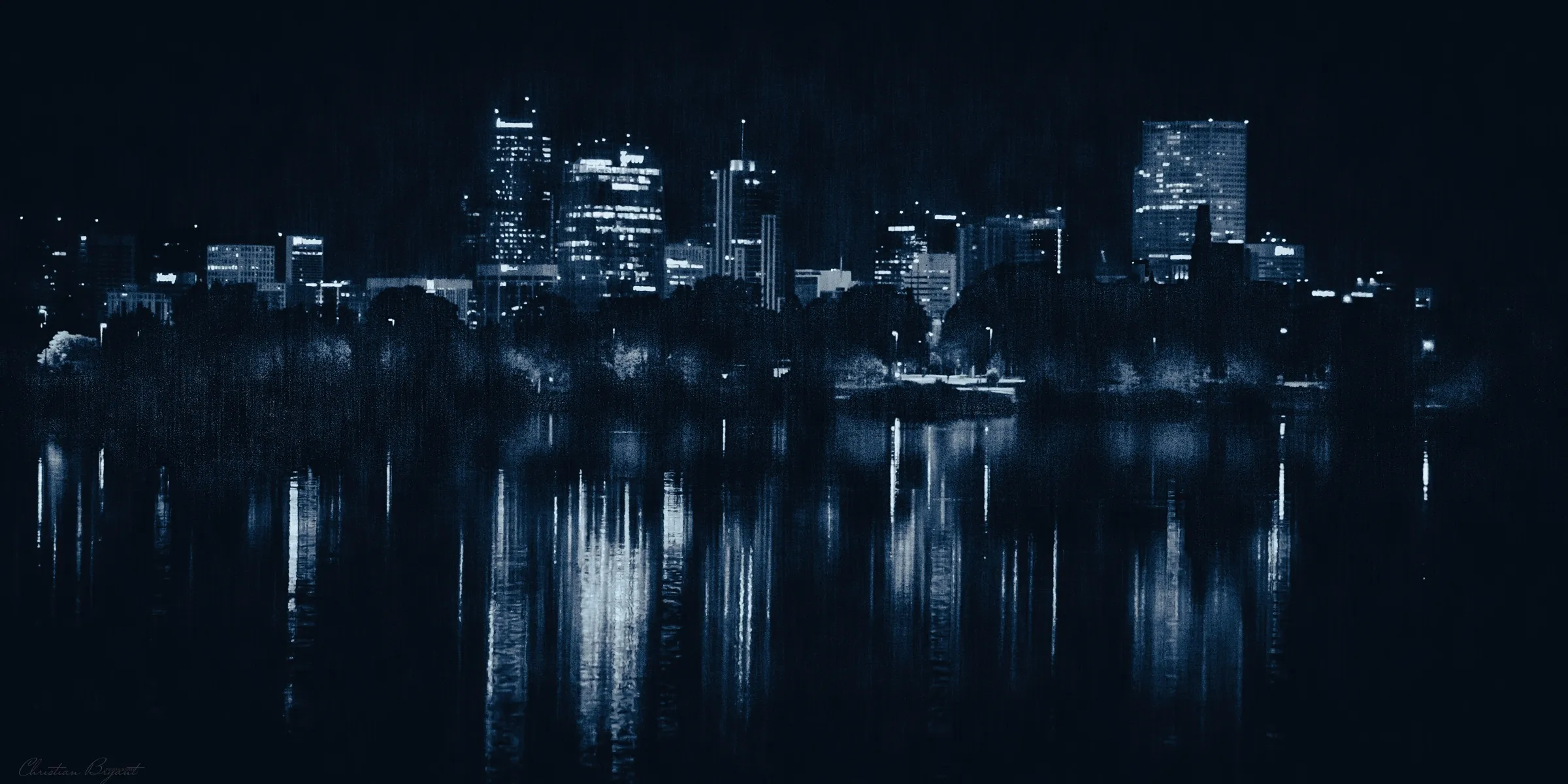 City skyline reflected in dark water